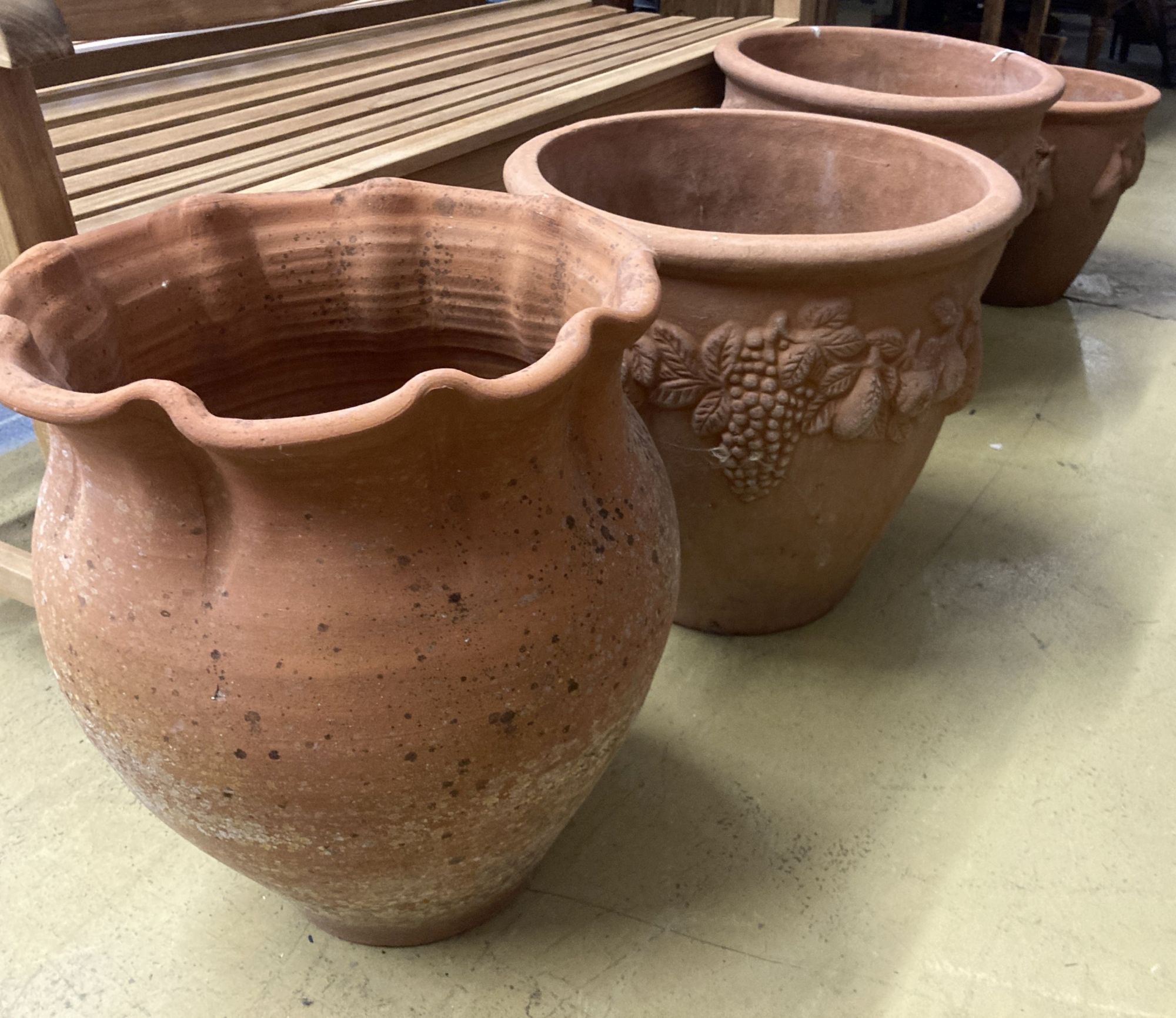 Four circular terracotta garden urns, largest 50cm diameter, 46cm high